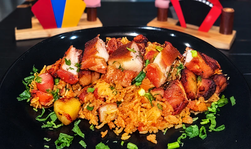 Arroz paisa: fried rice piled with pork, chorizo and chicharron