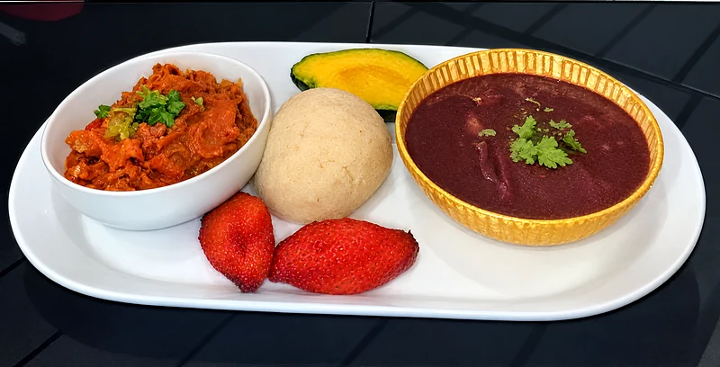 Burrito bowl lunch special: a bowl of red rice, a scoop of white rice, avocado, fried sweet plantain and a bowl of beans on a white platter