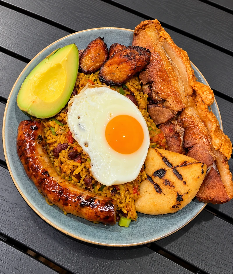 Calentado with rice and beans, a fried egg, chorizo, chicharron, avocado, fried plantain and a grilled arepa