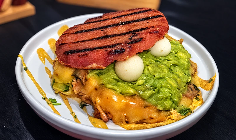 Pollo Loko arepa with pulled chicken, guacamole, quail eggs and cheese