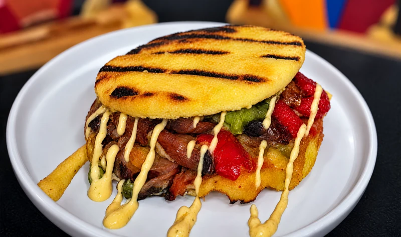 Veggie arepa with beans, sweet plantain, cheese and a drizzle of mayonnaise