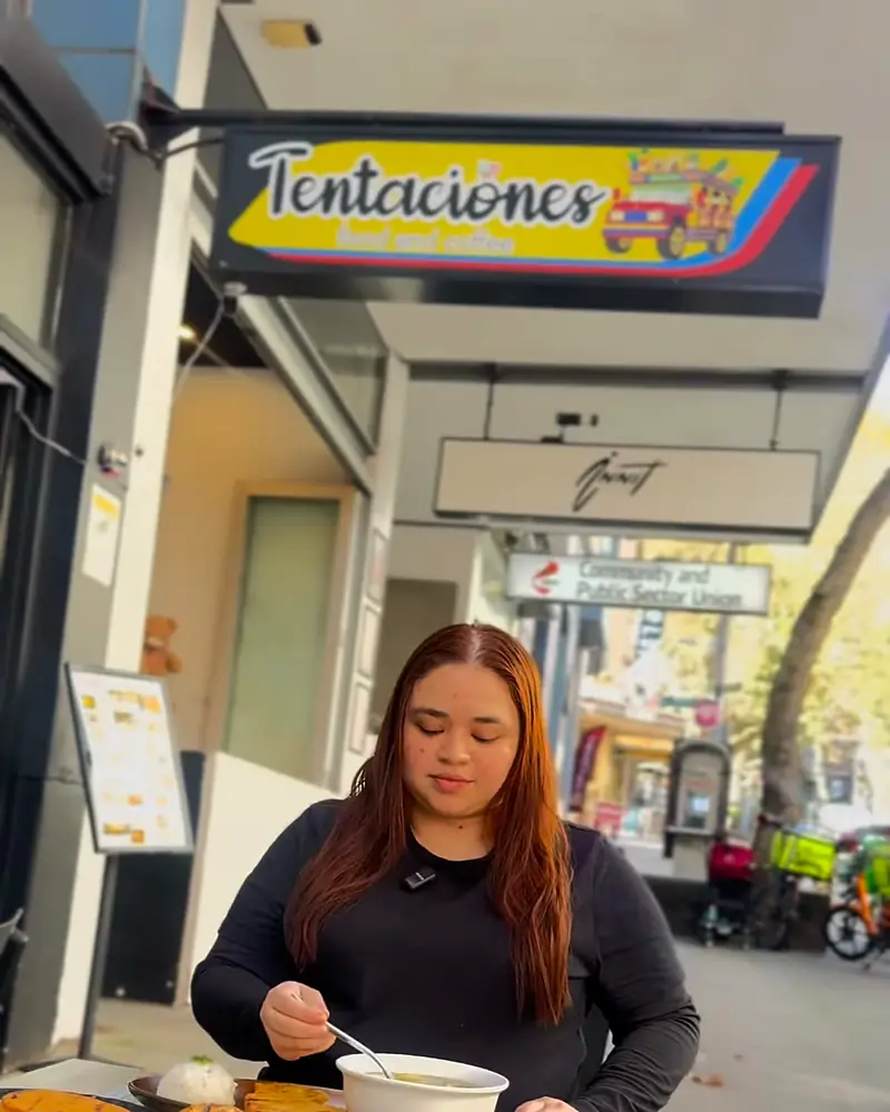 The yellow Tentaciones sign with its painted chiva bus over the tables on Foveaux Street